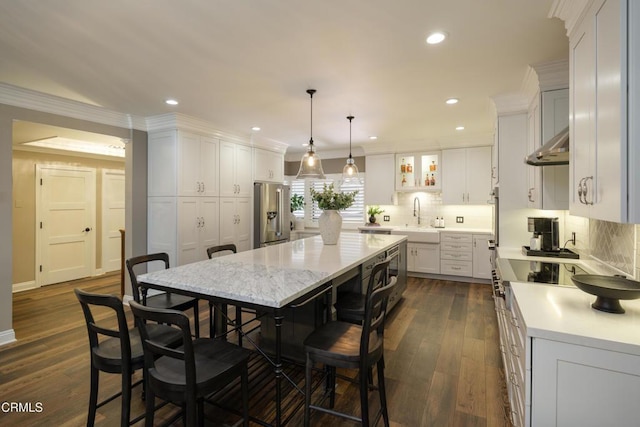 111 S Orange Grove Blvd Unit 203, Pasadena, CA 91105 - kitchen featuring stainless steel fridge with ice dispenser, a center island, tasteful backsplash, white cabinets, and a breakfast bar