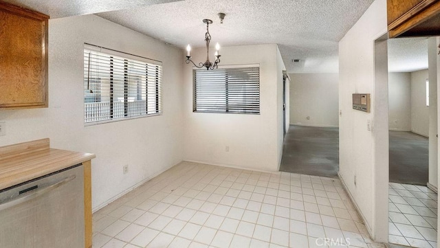 14927 Condon Ave Unit 7, Lawndale, CA 90260 - unfurnished dining area featuring plenty of natural light, a chandelier, and a textured ceiling