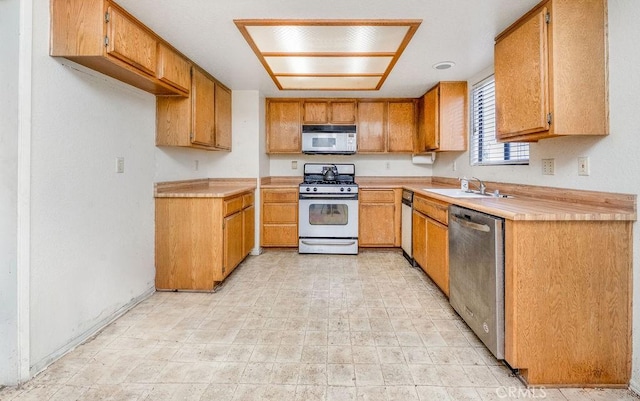 14927 Condon Ave Unit 7, Lawndale, CA 90260 - kitchen featuring stainless steel appliances, light countertops, and brown cabinetry