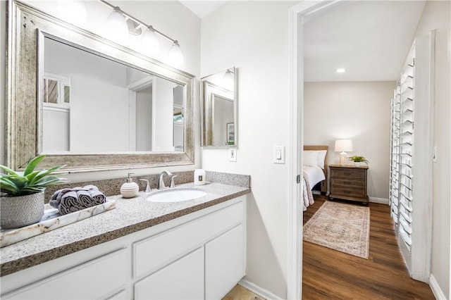 8761 Sandhill Dr, Riverside, CA 92508 - bathroom with wood finished floors, vanity, and ensuite bath