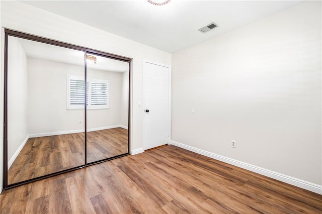 8761 Sandhill Dr, Riverside, CA 92508 - unfurnished bedroom featuring wood finished floors and a closet