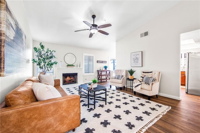 8761 Sandhill Dr, Riverside, CA 92508 - living room with wood finished floors, ceiling fan, a brick fireplace, and high vaulted ceiling