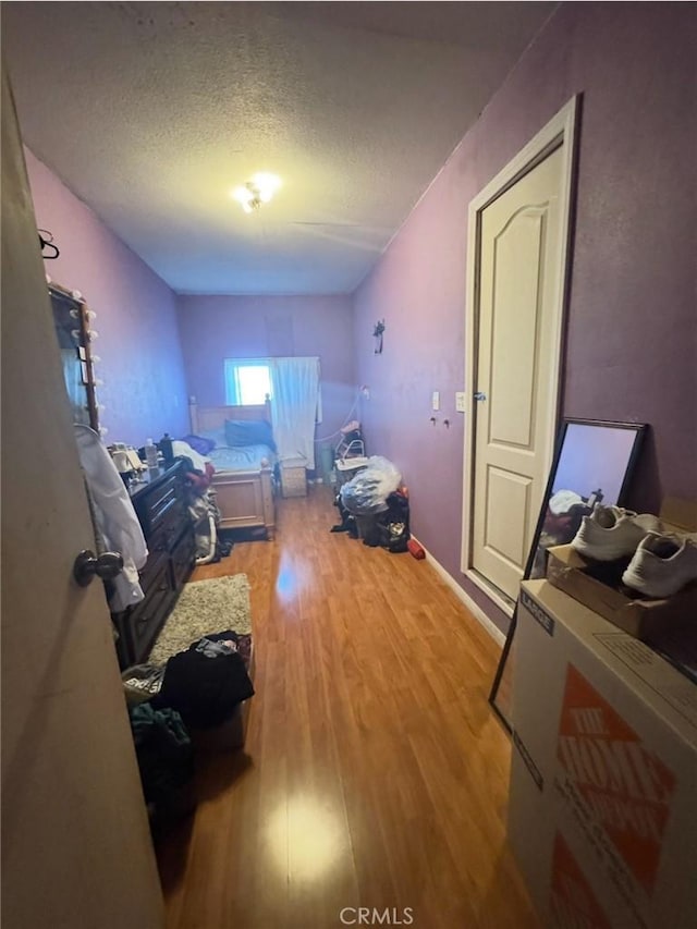 9167 Citrus Ave, Fontana, CA 92335 - bedroom featuring light wood-style flooring and a textured ceiling