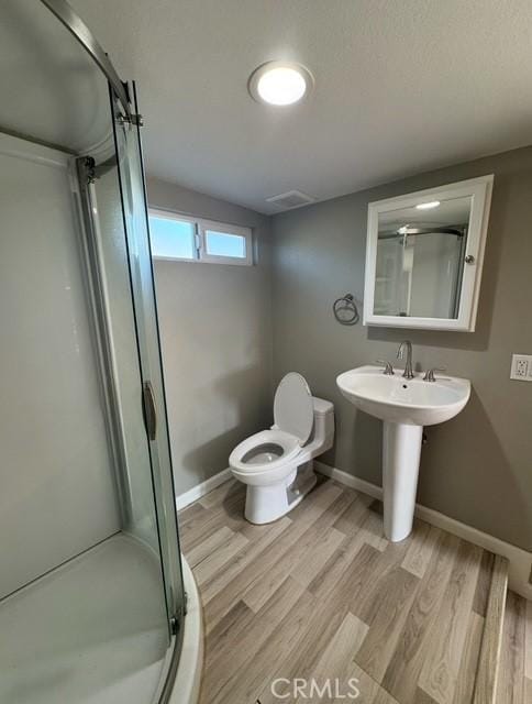 9167 Citrus Ave, Fontana, CA 92335 - bathroom featuring a shower stall and wood finished floors