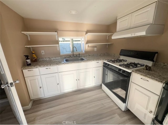 9167 Citrus Ave, Fontana, CA 92335 - kitchen featuring open shelves, white gas stove, under cabinet range hood, and light wood finished floors
