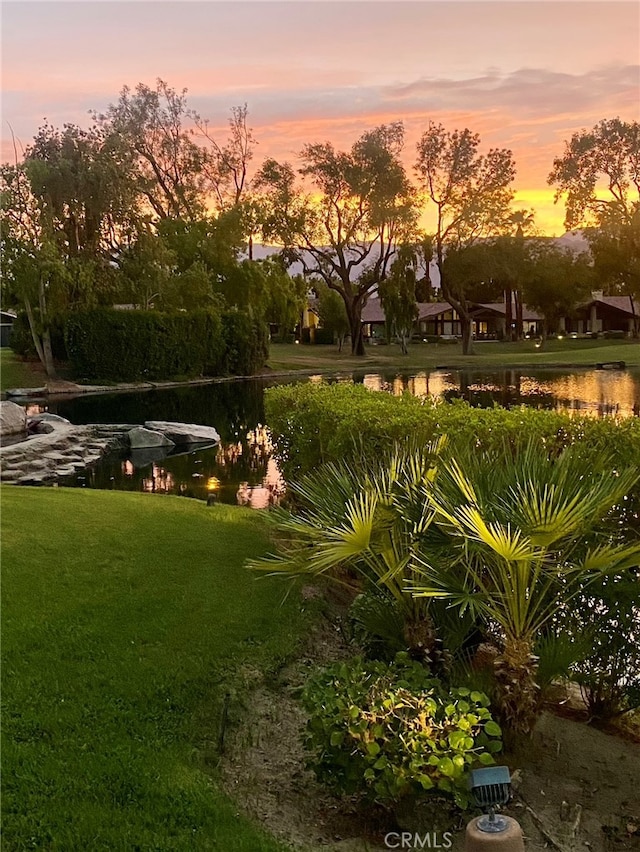 241 Wild Horse Dr, Palm Desert, CA 92211 - yard at dusk with a lawn and a water view