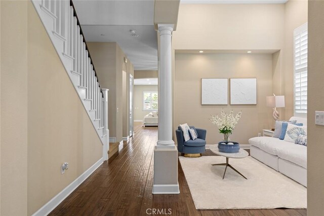 17472 Oakbluffs Ln, Huntington Beach, CA 92649 - living room featuring dark wood finished floors, decorative columns, stairs, and recessed lighting