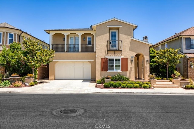 17472 Oakbluffs Ln, Huntington Beach, CA 92649 - mediterranean / spanish house with stucco siding, a balcony, concrete driveway, and an attached garage