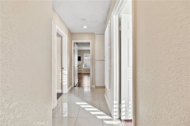 3718 Berkshire Rd, Pico Rivera, CA 90660 - hallway with a textured wall, light tile patterned flooring, and a textured ceiling