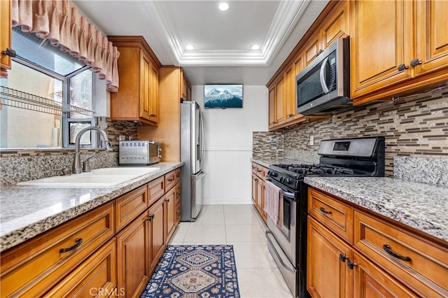 3718 Berkshire Rd, Pico Rivera, CA 90660 - kitchen featuring stainless steel appliances, ornamental molding, brown cabinets, tasteful backsplash, and a raised ceiling