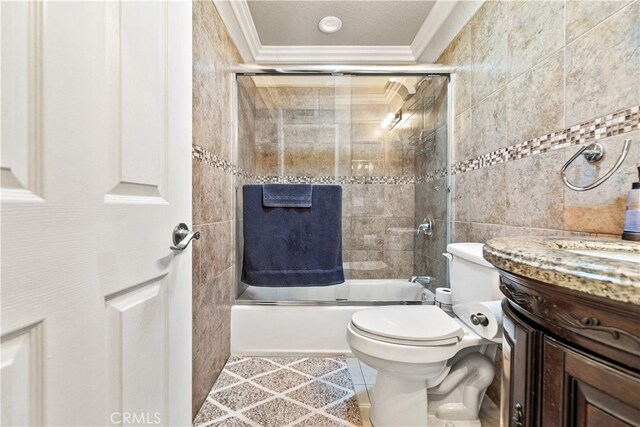 3718 Berkshire Rd, Pico Rivera, CA 90660 - bathroom featuring ornamental molding, tile walls, vanity, and combined bath / shower with glass door
