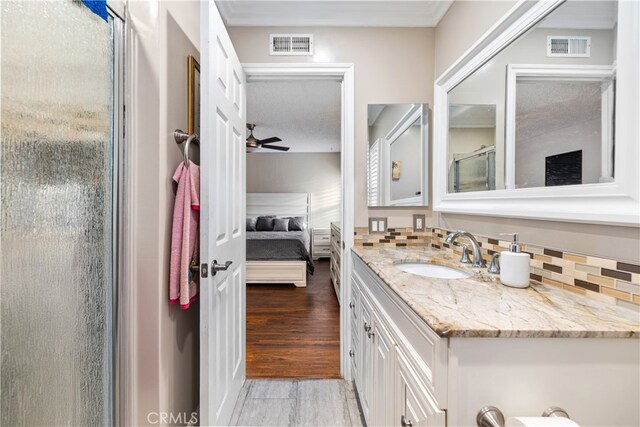 3718 Berkshire Rd, Pico Rivera, CA 90660 - ensuite bathroom with vanity, a ceiling fan, a shower with door, and decorative backsplash