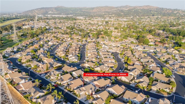 3718 Berkshire Rd, Pico Rivera, CA 90660 - aerial overview of property's location featuring a mountainous background and nearby suburban area