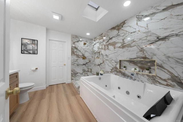 709 Puebla St, Encinitas, CA 92024 - full bathroom with a jetted tub, wood finished floors, vanity, a marble finish shower, and a skylight