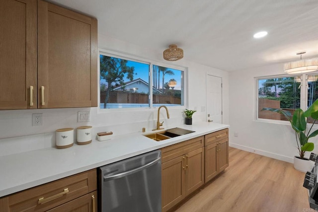 709 Puebla St, Encinitas, CA 92024 - kitchen with stainless steel dishwasher, light wood finished floors, light countertops, recessed lighting, and brown cabinets
