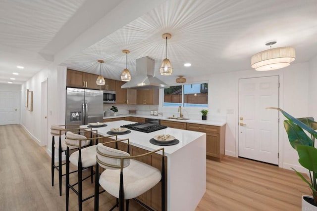 709 Puebla St, Encinitas, CA 92024 - kitchen featuring island exhaust hood, appliances with stainless steel finishes, light wood-style flooring, light countertops, and recessed lighting