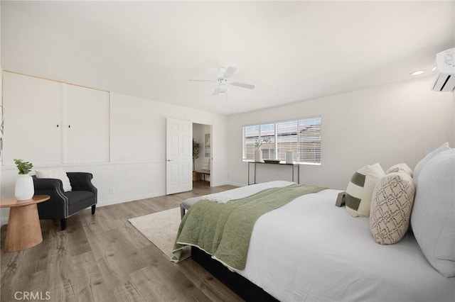 15352 Pastrana Dr, La Mirada, CA 90638 - bedroom featuring wood finished floors, a wall mounted air conditioner, and a ceiling fan
