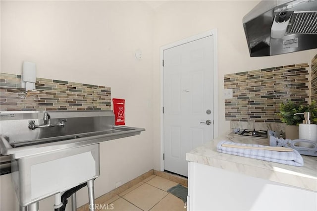 15352 Pastrana Dr, La Mirada, CA 90638 - kitchen featuring decorative backsplash, ventilation hood, light tile patterned floors, and light countertops