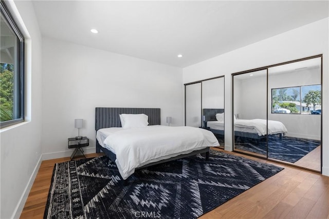 32641 Womsi Rd, Pauma Valley, CA 92061 - bedroom featuring two closets, wood finished floors, multiple windows, recessed lighting, and access to exterior