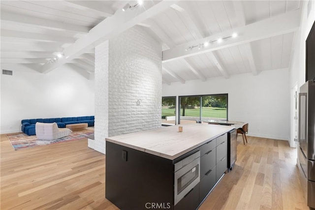 32641 Womsi Rd, Pauma Valley, CA 92061 - kitchen featuring stainless steel microwave, light wood-style flooring, modern cabinets, track lighting, and open floor plan