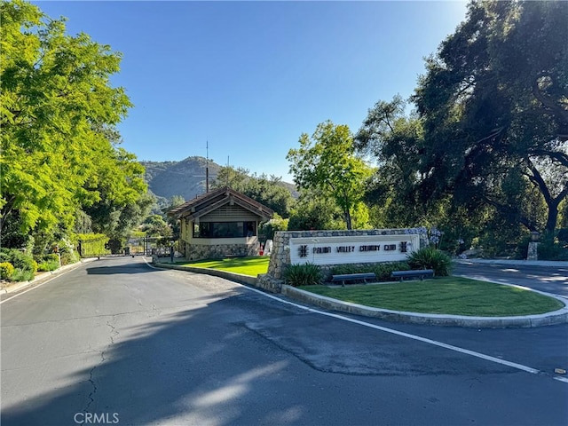 32641 Womsi Rd, Pauma Valley, CA 92061 - view of asphalt road with curbs, a mountain view, and a gated entry