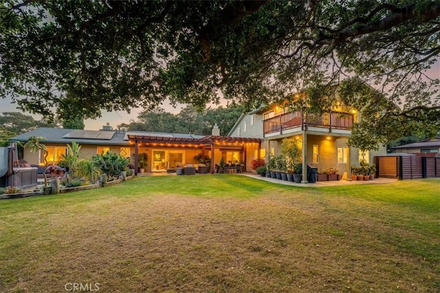 947 Calimex, Nipomo, CA 93444 - back of property with roof mounted solar panels, a yard, a balcony, and a chimney