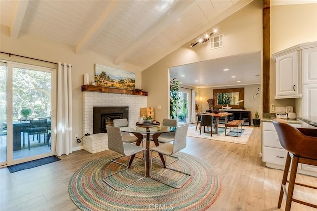 947 Calimex, Nipomo, CA 93444 - dining space with light wood-type flooring, beamed ceiling, healthy amount of natural light, a brick fireplace, and high vaulted ceiling