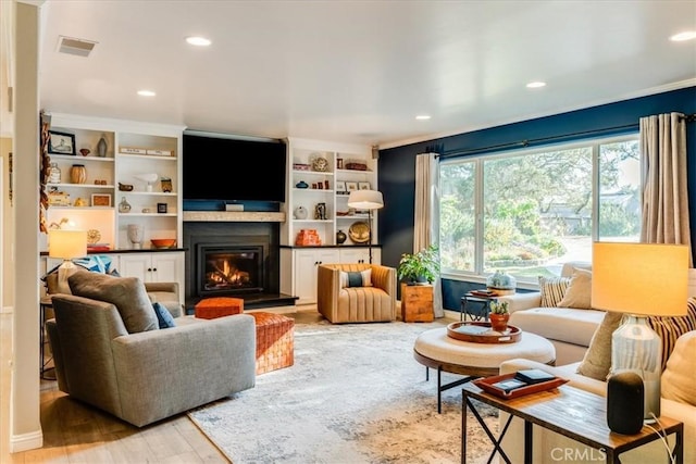947 Calimex, Nipomo, CA 93444 - living area featuring light wood finished floors, a glass covered fireplace, recessed lighting, and built in features