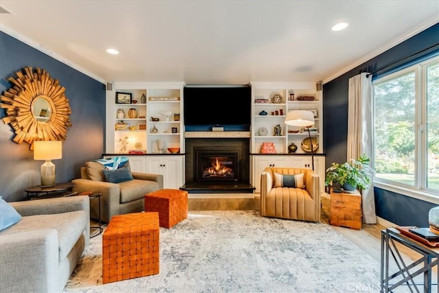 947 Calimex, Nipomo, CA 93444 - living area with wood finished floors, healthy amount of natural light, a glass covered fireplace, crown molding, and recessed lighting