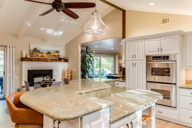 947 Calimex, Nipomo, CA 93444 - kitchen featuring double oven, a kitchen bar, ceiling fan, white cabinets, and recessed lighting