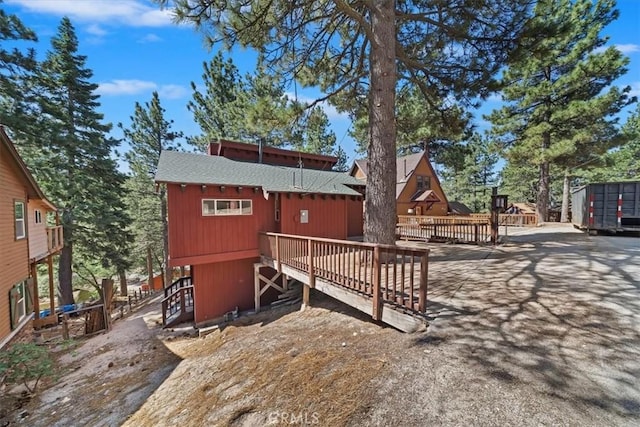 33211 Juniper Ln, Green Valley Lake, CA 92341 - back of property featuring a shingled roof and a wooden deck