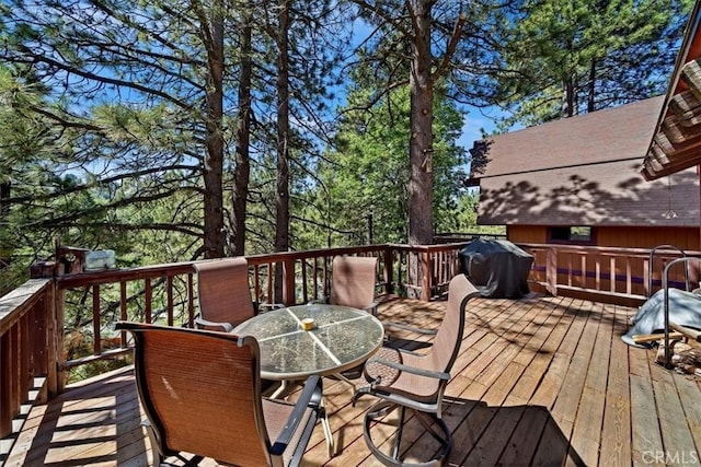 33211 Juniper Ln, Green Valley Lake, CA 92341 - wooden deck with outdoor dining space and a grill