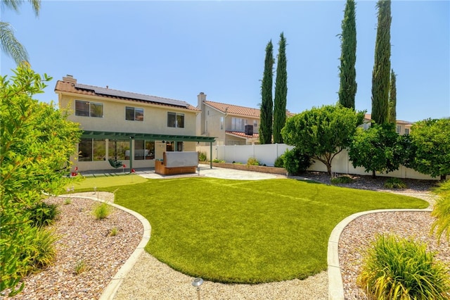 23832 Matador Way, Murrieta, CA 92562 - back of house with a patio area, a hot tub, roof mounted solar panels, a fenced backyard, and stucco siding
