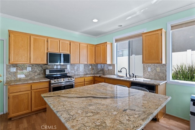 23832 Matador Way, Murrieta, CA 92562 - kitchen featuring appliances with stainless steel finishes, wood finished floors, crown molding, light stone countertops, and backsplash