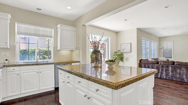 18 Via Canero, San Clemente, CA 92673 - kitchen with dark wood-type flooring, stainless steel dishwasher, a kitchen island, dark stone countertops, and open floor plan