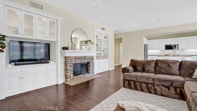 18 Via Canero, San Clemente, CA 92673 - living area featuring dark wood-style flooring, a fireplace, built in shelves, and recessed lighting