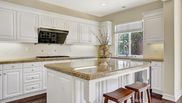 18 Via Canero, San Clemente, CA 92673 - kitchen featuring stainless steel gas cooktop, extractor fan, white cabinetry, a kitchen island, and dark wood-style flooring