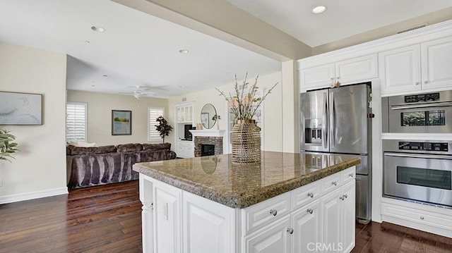 18 Via Canero, San Clemente, CA 92673 - kitchen with stainless steel appliances, recessed lighting, dark wood-style floors, a center island, and white cabinets