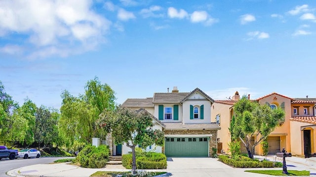 18 Via Canero, San Clemente, CA 92673 - view of front facade with an attached garage, stucco siding, driveway, a chimney, and stone siding