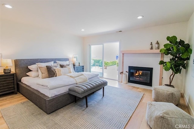 4026 Garfield St, Carlsbad, CA 92008 - bedroom featuring light wood finished floors, access to outside, a fireplace with flush hearth, and recessed lighting