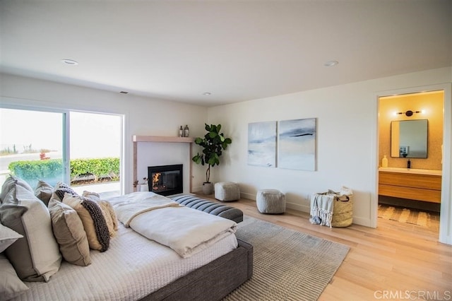4026 Garfield St, Carlsbad, CA 92008 - bedroom with light wood-type flooring, ensuite bath, a glass covered fireplace, and recessed lighting