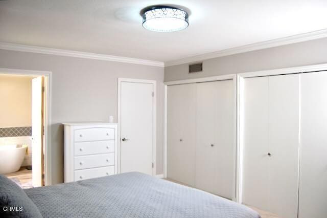 691 Via Ondulando, Ventura, CA 93003 - bedroom featuring two closets, crown molding, and connected bathroom