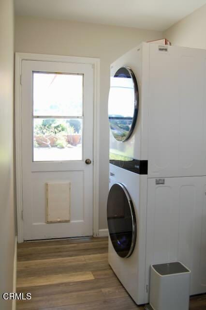 691 Via Ondulando, Ventura, CA 93003 - laundry room featuring stacked washer and clothes dryer, light wood-type flooring, and healthy amount of natural light