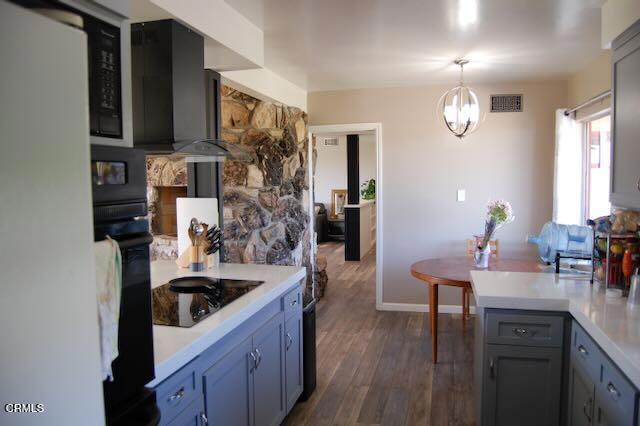 691 Via Ondulando, Ventura, CA 93003 - kitchen featuring black appliances, light countertops, decorative light fixtures, a chandelier, and dark wood-type flooring