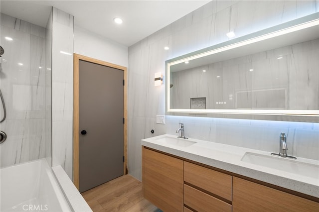 325 N Madison Ave, Monrovia, CA 91016 - full bathroom with wood finished floors, double vanity,  shower combination, and decorative backsplash