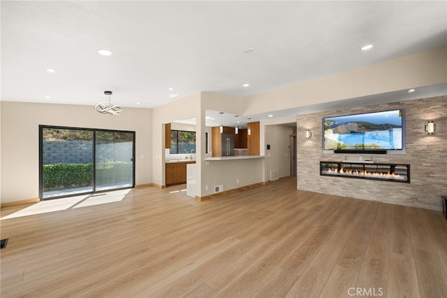325 N Madison Ave, Monrovia, CA 91016 - unfurnished living room with a glass covered fireplace, light wood finished floors, and recessed lighting