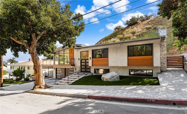 325 N Madison Ave, Monrovia, CA 91016 - contemporary house with french doors, a balcony, and stucco siding