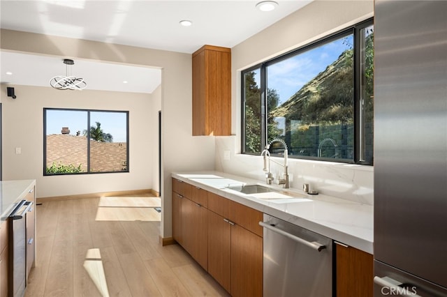 325 N Madison Ave, Monrovia, CA 91016 - kitchen featuring stainless steel appliances, plenty of natural light, brown cabinetry, light wood finished floors, and recessed lighting
