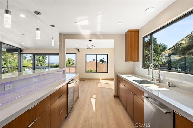 325 N Madison Ave, Monrovia, CA 91016 - kitchen featuring stainless steel dishwasher, brown cabinetry, decorative light fixtures, light wood-style floors, and recessed lighting