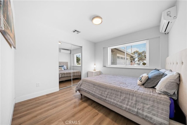 18536 Mescal St, Rowland Heights, CA 91748 - bedroom with a wall mounted AC, multiple windows, wood finished floors, and a closet